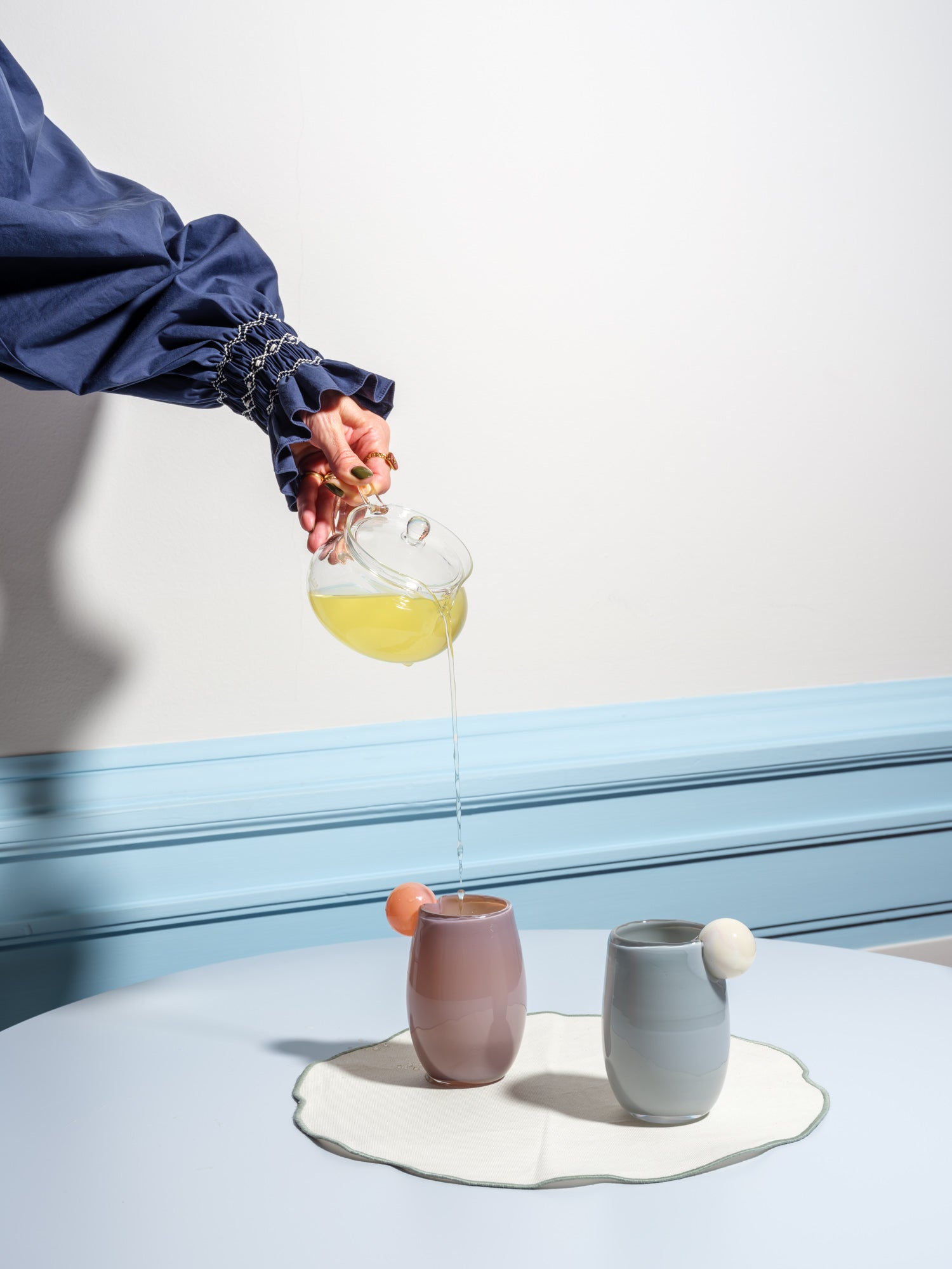 Cup made of glass with a ball on the side in light pink and purple